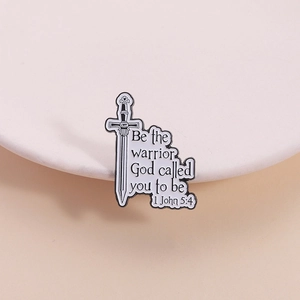 Detail of sword enamel brooch featuring 'Be the warrior God called you to be' quote