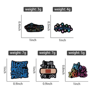 Detailed view of colorful Coldplay lyrics enamel pins with sizes and weights shown