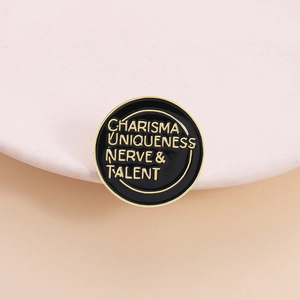 Charisma Uniqueness Nerve Talent enamel pin brooch with gold trim on a black base