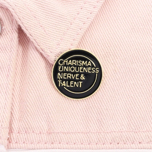 Macro shot of charisma uniqueness nerve talent enamel pin on pink denim fabric lapel