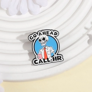 Cartoon skeleton enamel pin wearing tie with Go Ahead Call HR text for work outfits
