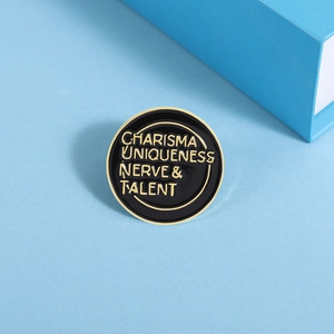Detail of round black enamel charisma uniqueness nerve and talent pin on blue background