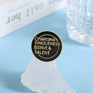 Enamel lapel pin with Charisma Uniqueness Nerve and Talent text on white crystal