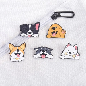 Detail view of five cute cartoon dog enamel pins displayed on white canvas fabric