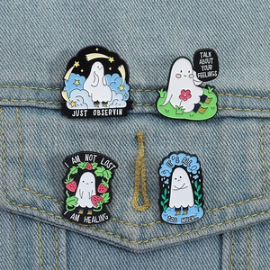 Set of 4 cute ghost enamel pins with different moods pinned on denim pocket fabric