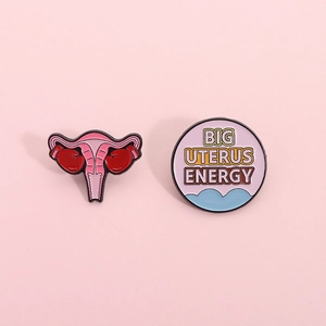 Cartoon uterine metal enamel pins set with boxing gloves and Big Uterus Energy text