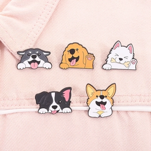 Detailed view of five cute enamel dog pins on pink denim, including Corgi and Golden Retriever