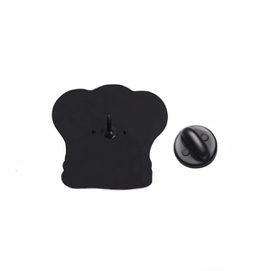 Detail view of the black matte metal badge back with rubber clutch for secure pinning