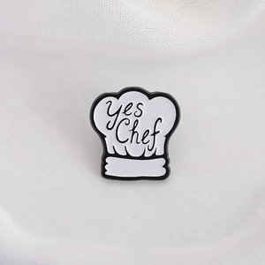 Creative chef hat enamel brooch with Yes Chef lettering and black outline design