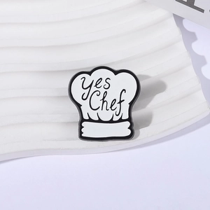 Minimalist white chef hat enamel pin with Yes Chef lettering and black metal trim