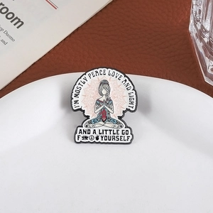 Creative yoga meditation enamel pin with mandala pattern on a white display plate