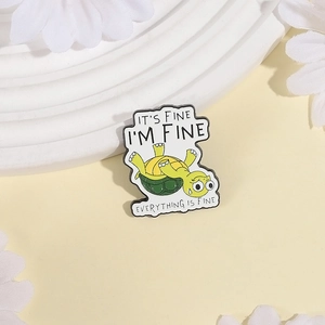Close-up of enamel turtle pin with humor text I'm Fine and polished metal finish