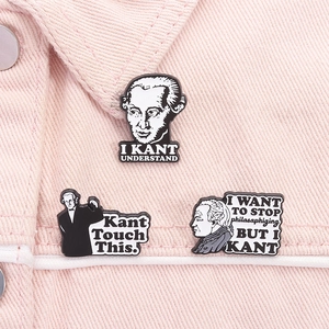 Detailed view of three Immanuel Kant enamel pins attached to a pink denim jacket