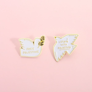 Pair of white enamel peace dove pins with Free Palestine text and gold metal edges
