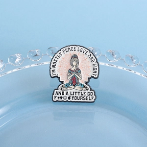 Close-up of a cartoon yoga girl enamel brooch with a mandala background design