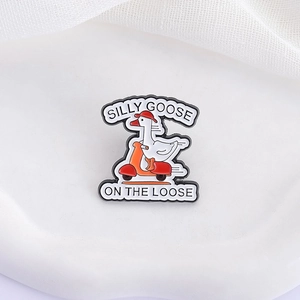 Funny Silly Goose on the Loose enamel pin showing a white duck riding a red scooter