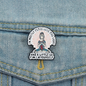 Funny yoga meditation enamel pin with peace and love quote on blue denim jacket