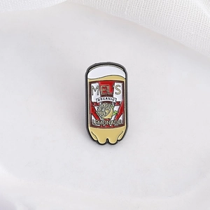Retro Mel's Organic Lemonade enamel pin featuring a vibrant yellow metal bottle design