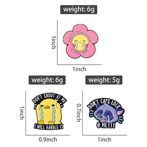 Detailed view of creative enamel pins featuring sad duck and raccoon with funny slogans