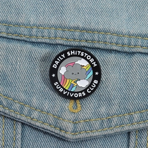 Daily Shitstorm Survivor Club round enamel pin badge on light blue denim jacket pocket