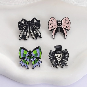 Set of four Gothic Halloween enamel pins with bow shapes, ghosts and skull designs