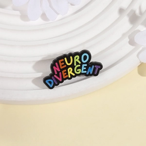 Rainbow Neurodivergent alloy enamel pin on a minimalist white decorative display