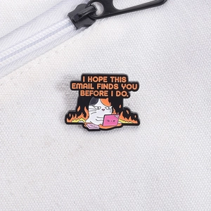 Close-up of angry cat enamel pin on white canvas bag with work-humor slogan text