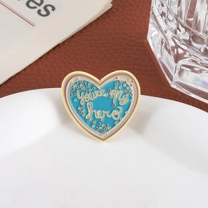 Spilla in smalto a cuore blu con scritta You're my hero su vassoio bianco