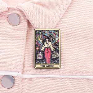 Detail of tarot style ADHD enamel pin on pink denim jacket with colorful oil painting design