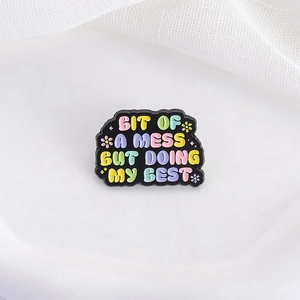 Rainbow enamel pin with slogan BIT OF A MESS BUT DOING MY BEST on white background