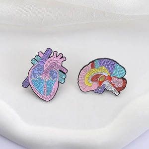 Creative anatomical enamel pins featuring colorful brain and heart designs with medical terms