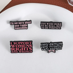 Set of four cute enamel badges with empowering English slogans for bags and clothes