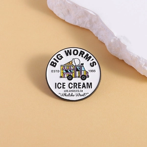 Close-up of enamel ice cream truck badge with Big Worm's Ice Cream text on round metal pin