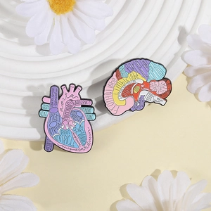 Creative anatomical brain and heart enamel pin set in pastel colors with medical labels