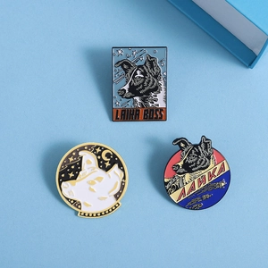 Three Soviet space dog Laika enamel pins featuring Laika Boss text and rocket designs