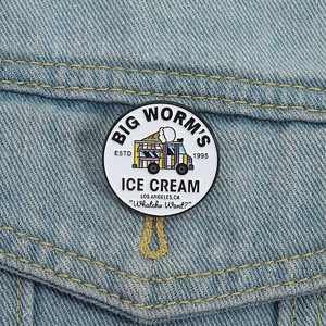 Round metal enamel ice cream truck brooch badge pinned on a blue denim jacket pocket
