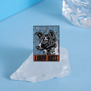 Macro shot of Laika Boss space dog enamel pin resting on white quartz crystal