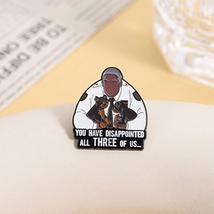 Macro shot of a metal enamel police character pin with quote and dogs detail