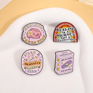 Pink mental health enamel pins set with cute brain and rainbow designs on white tray