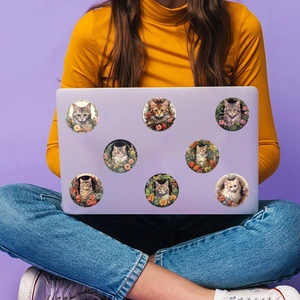 Detail of 8 vintage cat and floral stickers on a purple laptop case for decoration