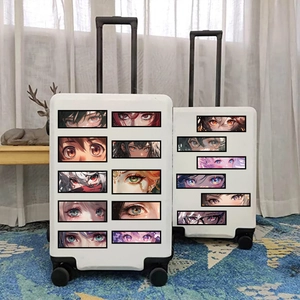 Anime eye stickers on a white suitcase showing diverse colorful manga art styles