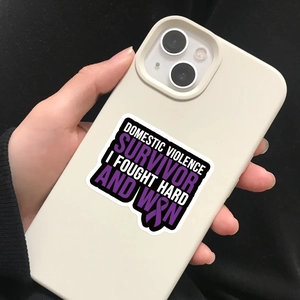 Domestic violence survivor sticker on a phone case with purple ribbon and bold text