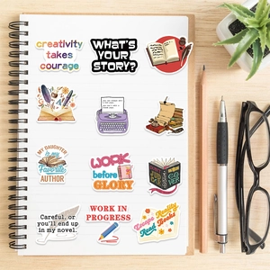 Detail of artistic reading and writing stickers on a spiral notebook with a wooden background