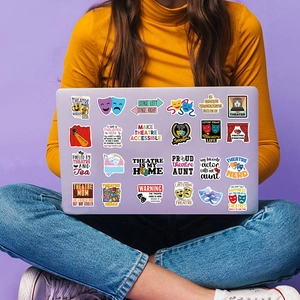 Waterproof theatre themed stickers shown as creative decoration on a purple laptop cover