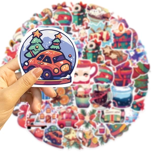 Close-up of waterproof Christmas stickers featuring festive trees and gift boxes