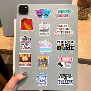 Detailed view of theater stickers on iPad showcasing vinyl drama-themed art and slogans