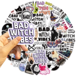Close-up of waterproof Bad Witch Vibes stickers with purple and black gothic designs