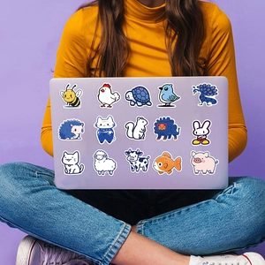 Blue animal stickers applied on a purple laptop cover showing diverse cute characters