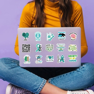 Close-up of 15 waterproof mental health awareness stickers on a laptop lid