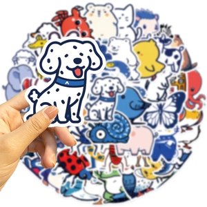 Hand holding a blue dalmatian cartoon sticker from a 50pcs waterproof animal collection